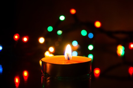 Wax candles burn in dark light. Wax candle. Burning fire Light from the fireの写真素材