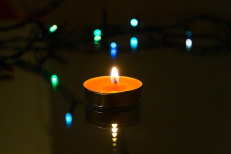 Wax candles burn in dark light. Wax candle. Burning fire Light from the fireの写真素材