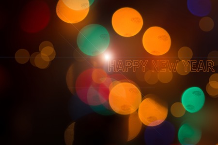 Bokeh from a garland on a black background. Banner Happy New Year. Postcard Happy New Year....