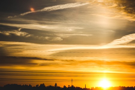 Landscape outside the city. Grassy field and blue sky. Sunset over the village field. Sunset outside the city in the fieldの写真素材