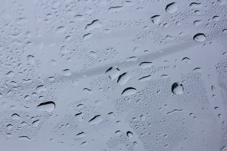 Drops of water on the glass. Background of water drops flowing down the glass. Texture of water...