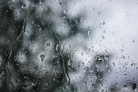 Drops of water on the glass. Background of water drops flowing down the glass. Texture of water droplets. Natural water, wet dropsの写真素材