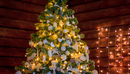 Decorated Christmas tree on blurred, sparkling and fairy backgroundの写真素材