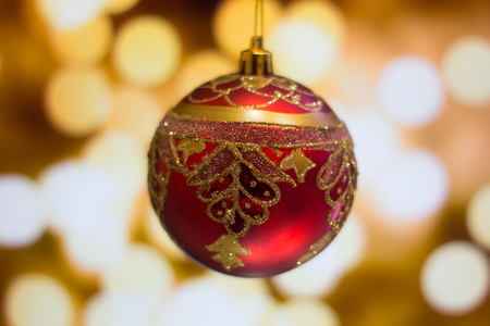 Christmas bauble on bokeh background.の写真素材