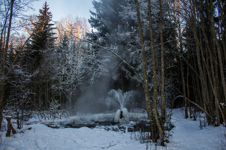 Gatchina geysers in winter. A jet of water up from the ground. Ice growths from waterの写真素材
