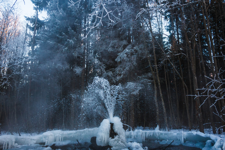 Gatchina geysers in winter. A jet of water up from the ground. Ice growths from waterの写真素材