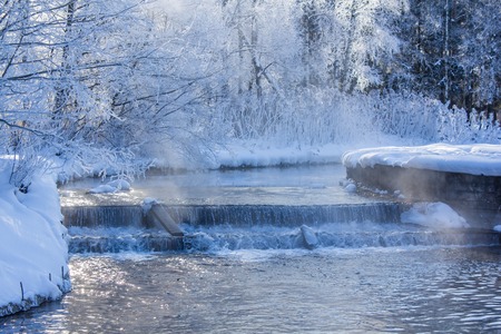 Winter landscape in clear weather. Morning bright sun. Snow plays shine. Winter picture. Frosty Snow Parkの写真素材