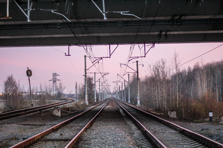 railway at sunset public transport. transportation of people and freight. travel around cities and countriesの写真素材