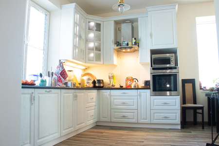 White kitchen. Wooden kitchen. Modern furniture and kitchen interior. Kitchen to individual sizes. White cabinets, gray handles, drawers, cabinet doorsのeditorial素材