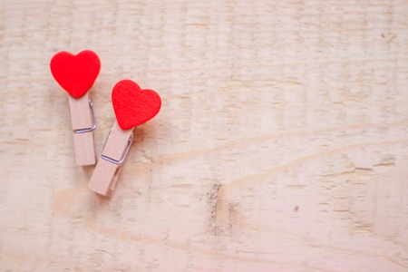 Clothespins with a heart on a wooden