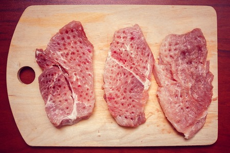 A piece of chicken fillet is fried in vegetable oil in a frying pan. Harmful fried food. Cholesterol. Vegetable oil. Food and Drink. Chicken breast filletの写真素材