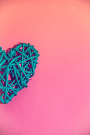 Heart of rattan on a pink background. Valentine's Day. Holiday decoration. Rattan material.の写真素材