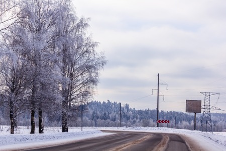 Snowy winter road. The road is covered up. Russian dear. Winter fairy tale out of townの写真素材
