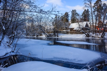 Spring landscape on the river. Ice is melting on the river. Sunny march day. Country nature. Proiroda outside the city. Russian province.の写真素材