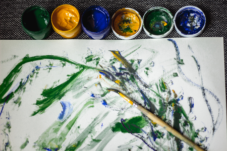 Drawing a small child on paper paints. Abstract children's drawingの写真素材