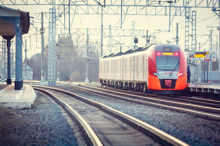 Train on the platform. Electric train on the railway. Russian railway. Station Lyuban, Russia, Leningrad Region April 7, 2018のeditorial素材