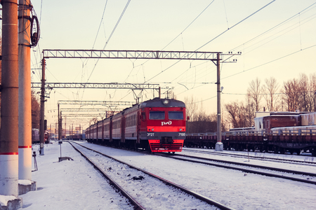 Train on the platform. Electric train on the railway. Russian railway. Platform Preportovaya, Russia, St. Petersburg, March 5, 2018のeditorial素材