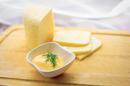 Cheese and cheese sauce on the board. Food and Drink. Milk productsの写真素材