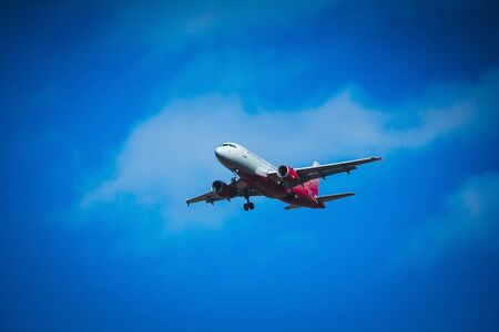 The plane flies in the sky in clear weather. Airplane in the sky. Airplane before landing. The plane is flying. Russia, St. Petersburg, April 27, 2018のeditorial素材