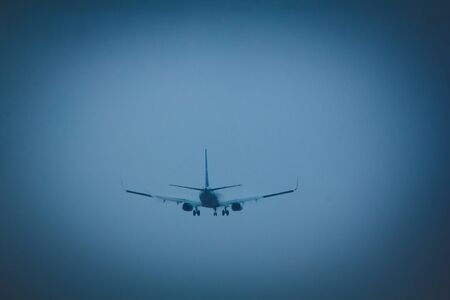 The plane flies in the sky in rainy weather. Airplane in the sky. Airplane before landing. The plane...