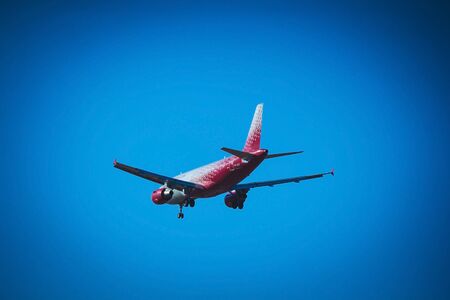 The plane flies in the sky in clear weather. Airplane in the sky. Airplane before landing. The plane is flying. Russia, St. Petersburg, April 27, 2018のeditorial素材