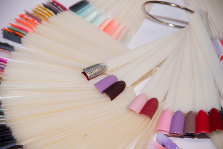Nail Care And Manicure concept. Multicolor Nail Polish palette for Client's Nails choise. Woman In Beauty Salon. Copyspace for text . variety of choice of color and design gel varnish. gel polishの写真素材