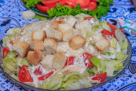 Caesar salad plate. Festive Salad. Greek salad . Delicious salad with chicken and crackersの写真素材