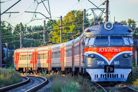 The train is on the rails in the evening. Russian railway. Electric train Russia, Leningrad region, Gatchina, August 8, 2018のeditorial素材