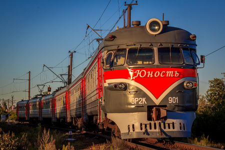 The train is on the rails in the evening. Russian railway. Electric train Russia, Leningrad region, Gatchina, August 8, 2018のeditorial素材