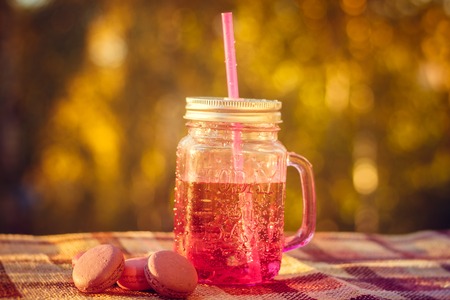 homemade lemonade and pasta macarons. Summer cold drink. Lemonade in a glass
