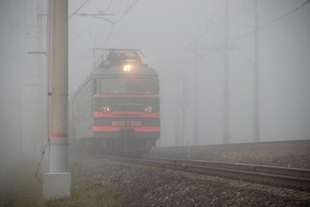 Locomotive rides by rail. Iron foggy road. Russian railway. Russia, Gatchina October 17 2018
