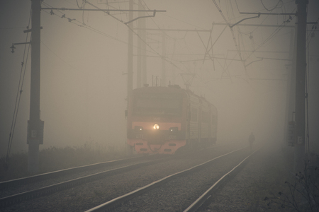 The train goes to the fog by rail. Russian railway. Misty railway. Russia, Gatchina October 17, 2018のeditorial素材