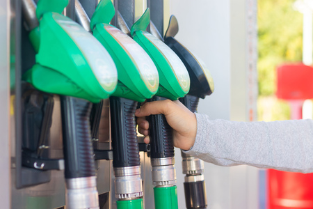 A man fills the car with gasoline. The man at the gas station. Refueling machines. Gasoline at a gas...