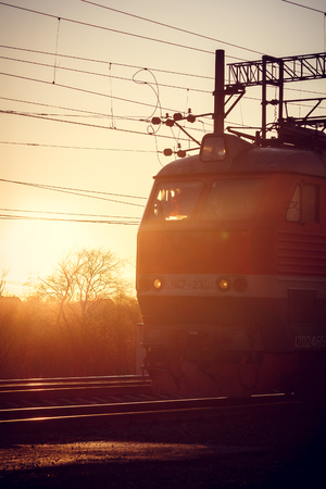 Locomotive rides on the Russian railway at sunset. Russian railway. Railway at sunset. Russia, Leningrad region, the village of Lyuban, evenings April 6 and 7, 2018のeditorial素材