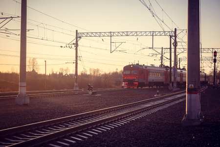 Locomotive rides on the Russian railway at sunset. Russian railway. Railway at sunset. Russia, Leningrad region, the village of Lyuban, evenings April 6 and 7, 2018のeditorial素材