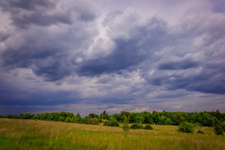 Summer field landscape before the rain. Summer landscape. The sky before the stormの写真素材