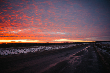 Unusual beautiful sunset over the road. sunset and road. Beautiful skyの写真素材