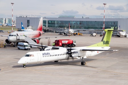 The plane goes to the airport. Air Transport. Transportation of people. Public transport. Airbaltic airplane. Russia, St. Petersburg, Pulkovo, official spotting on August 15, 2018のeditorial素材