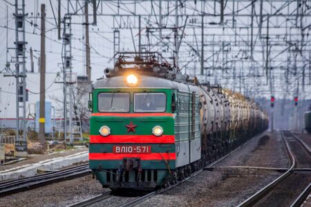 Locomotive rides outside the city. Shipping. Russian railway. Railway in the fall. Locomotive rides in the fall. Overcast weather . Russia Leningrad Oblast, Troopskovitsy Station on November 23, 2018のeditorial素材
