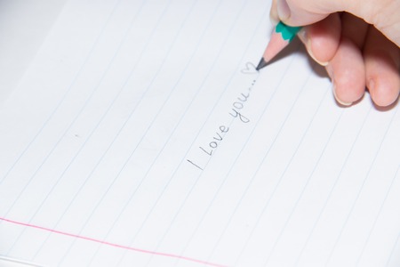 Text in pencil on paper I love you. Declaration of love on paper. Text on paper. I love you. Text...