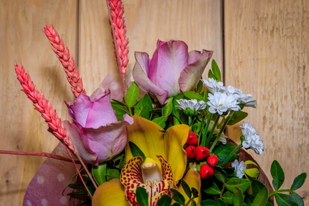 Bouquet with roses on wooden background. Bouquet of flowers. Wooden backgroundの写真素材