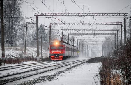 The train rides by rail. Russian train. Passenger transportation. Public transport. Winter railway. Russian railway. Russia Leningrad region, Suyda settlement on December 12, 2018のeditorial素材