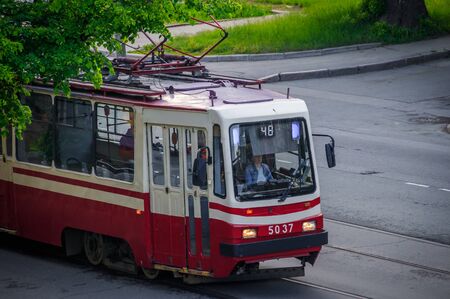 Tram rides in the city. Urban transport. Passenger transportation. Red tram. Russia, St. Petersburg May 31 2019のeditorial素材