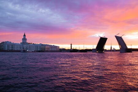 The bridges are erected at dawn in St. Petersburg. Peter Romance. Sight of Peter. Neva River. Dawn in the city. White Nights. Drawbridgesの写真素材