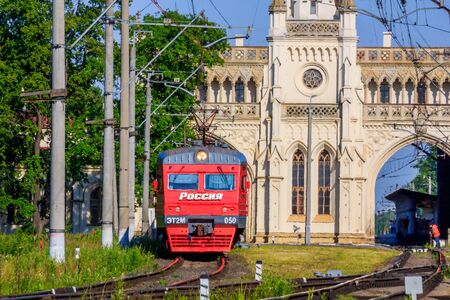 Russian train in the summer. The train is coming to the station. Russian railway. Russia, Leningrad region, Peterhof, June 20.のeditorial素材