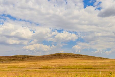Russian open spaces. Crimea. Field. Summer Russian landscapes. Road views. Grass and sky. Background...