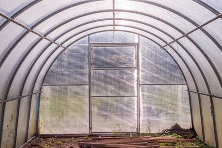 Greenhouse. Bright greenhouse in the garden. Agricultural harvest. Indoor stationary greenhouseの写真素材