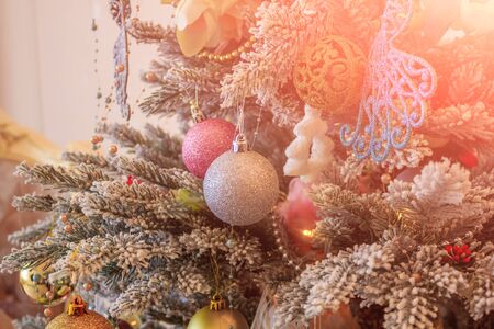 New Year's toys hang on a Christmas tree. Christmas tree decoration. Decor New Year's and Christmas.の写真素材