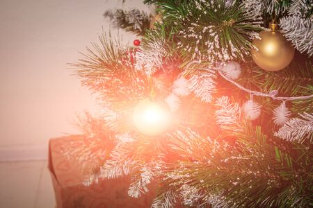 New Year's toys hang on a Christmas tree. Christmas tree decoration. Decor New Year's and Christmas.の写真素材