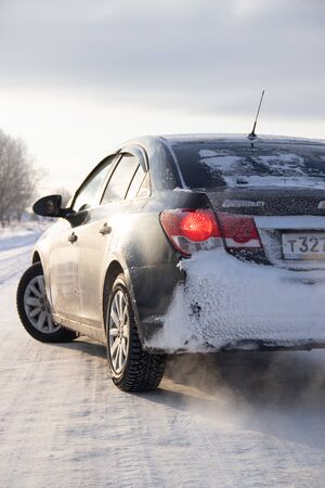 Black car on winter snowy road . Winter road. Journey. Russia, Gatchina 22 January 2019のeditorial素材